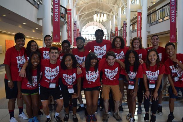 A group of students wearing red Morrill Scholars shirts pose in the Ohio Union