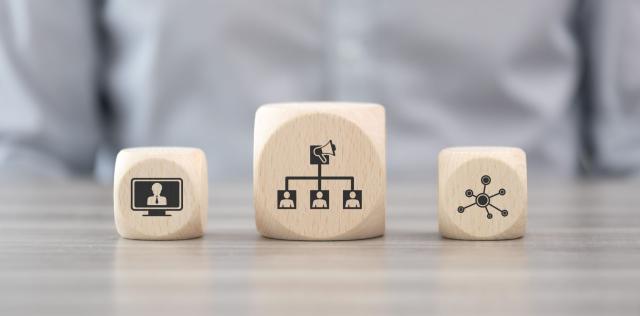 Wooden blocks with images of a computer screen, link tree and starburst