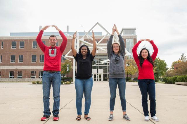 Four students with arms raised for OH-IO!