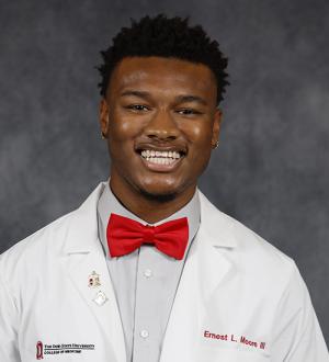 Ernest Moore III in his physician's white coat and red bowtie